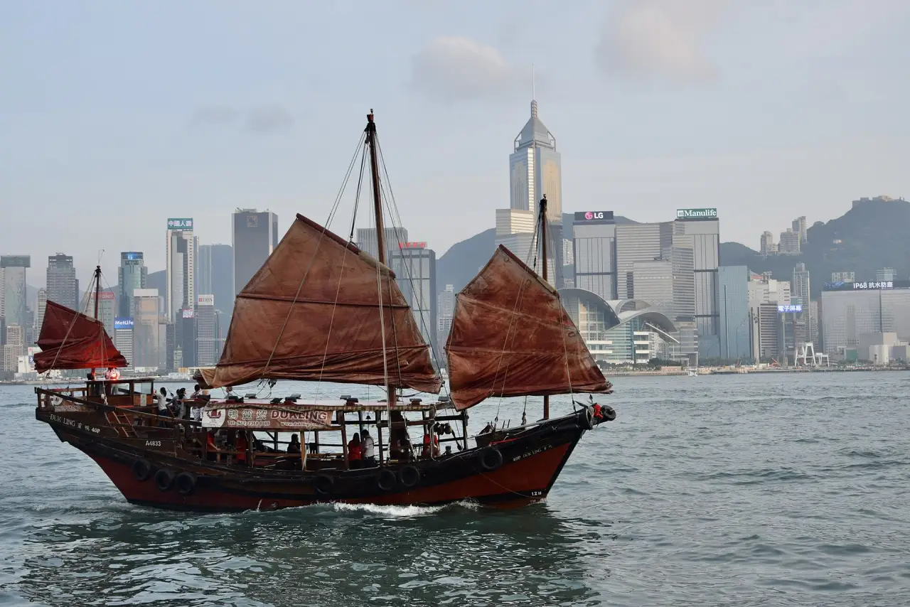 Red-sailed junk boat in Victoria Harbour