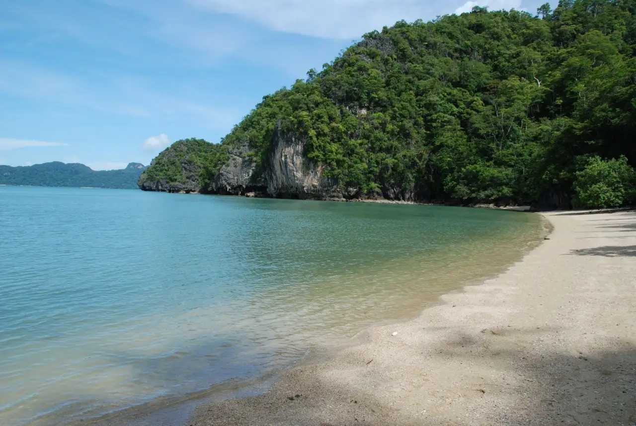 A quiet bay below the limestone cliffs, Langkawi A quiet bay below the limestone cliffs, Langkawi